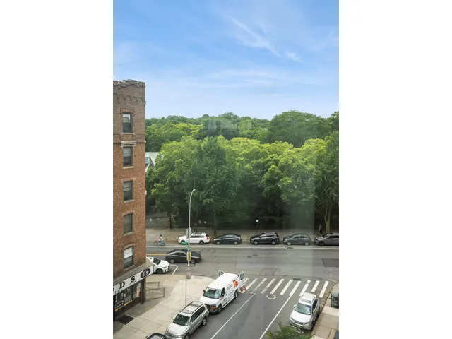 a living room with furniture a flat screen tv and a floor to ceiling window
