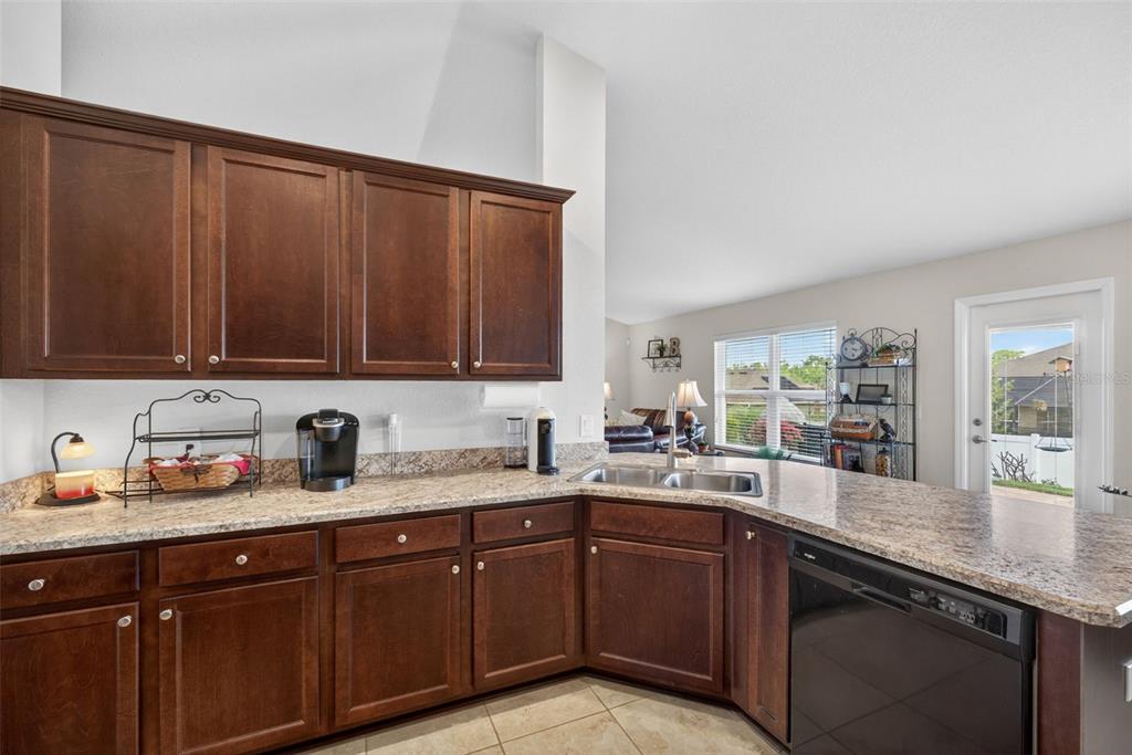 2429 Twin Lake View Road Winter Haven, FL 33881 - Photo 11 of 37 a kitchen with a sink a stove cabinets and wooden floor