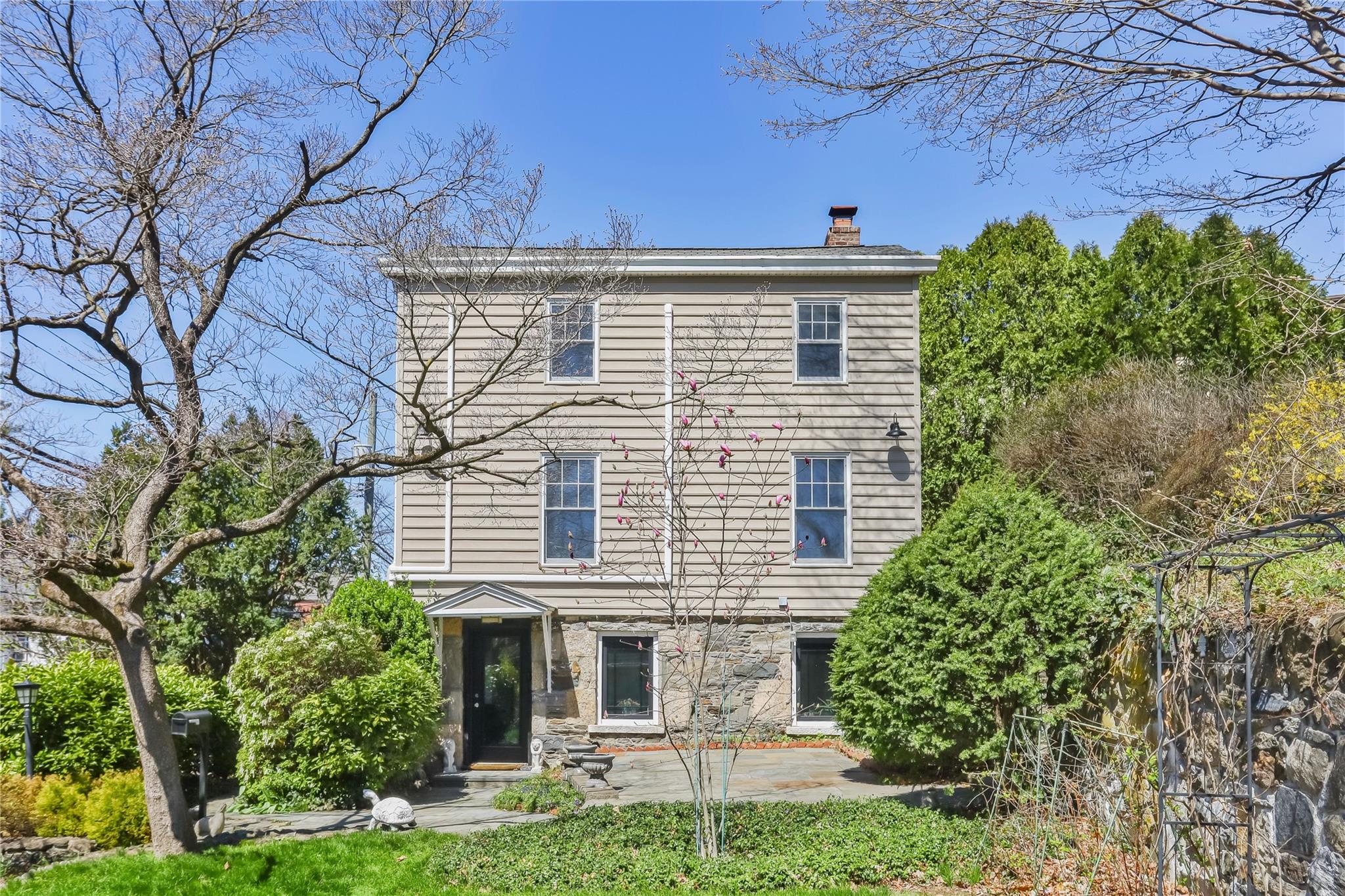 354 Bronxville Road Bronxville, NY 10708 - Photo 1 of 1 front view of a house with a garden