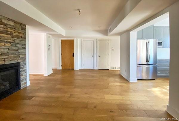 125 Warren Street Hudson, NY 12534 - Photo 12 of 25 a view of empty room with a fireplace and wooden floor