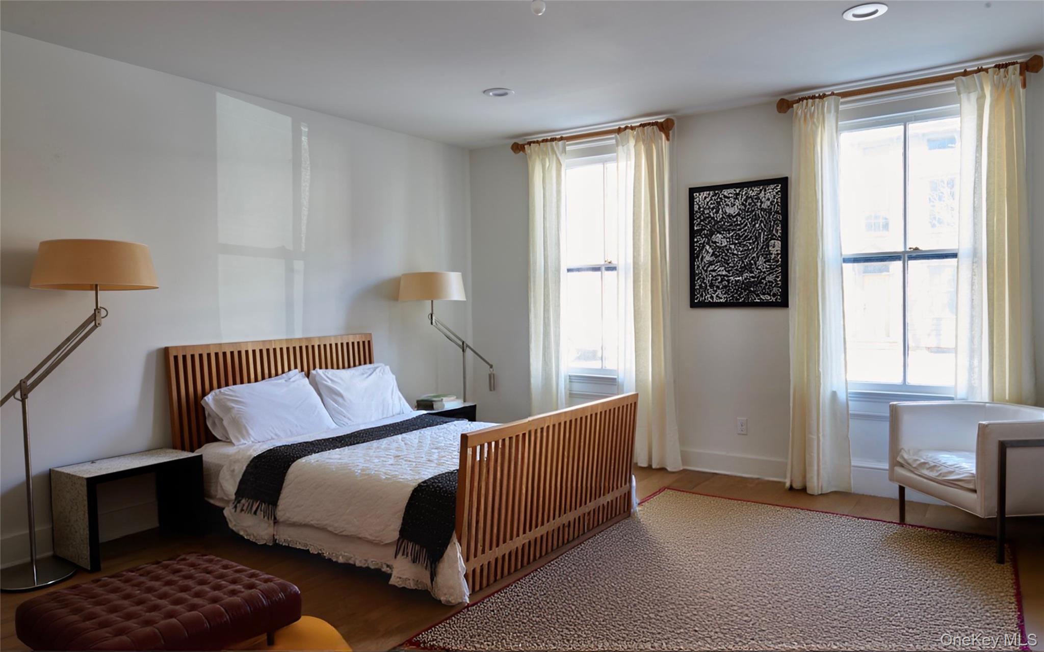 125 Warren Street Hudson, NY 12534 - Photo 17 of 25 a bedroom with a bed and a window