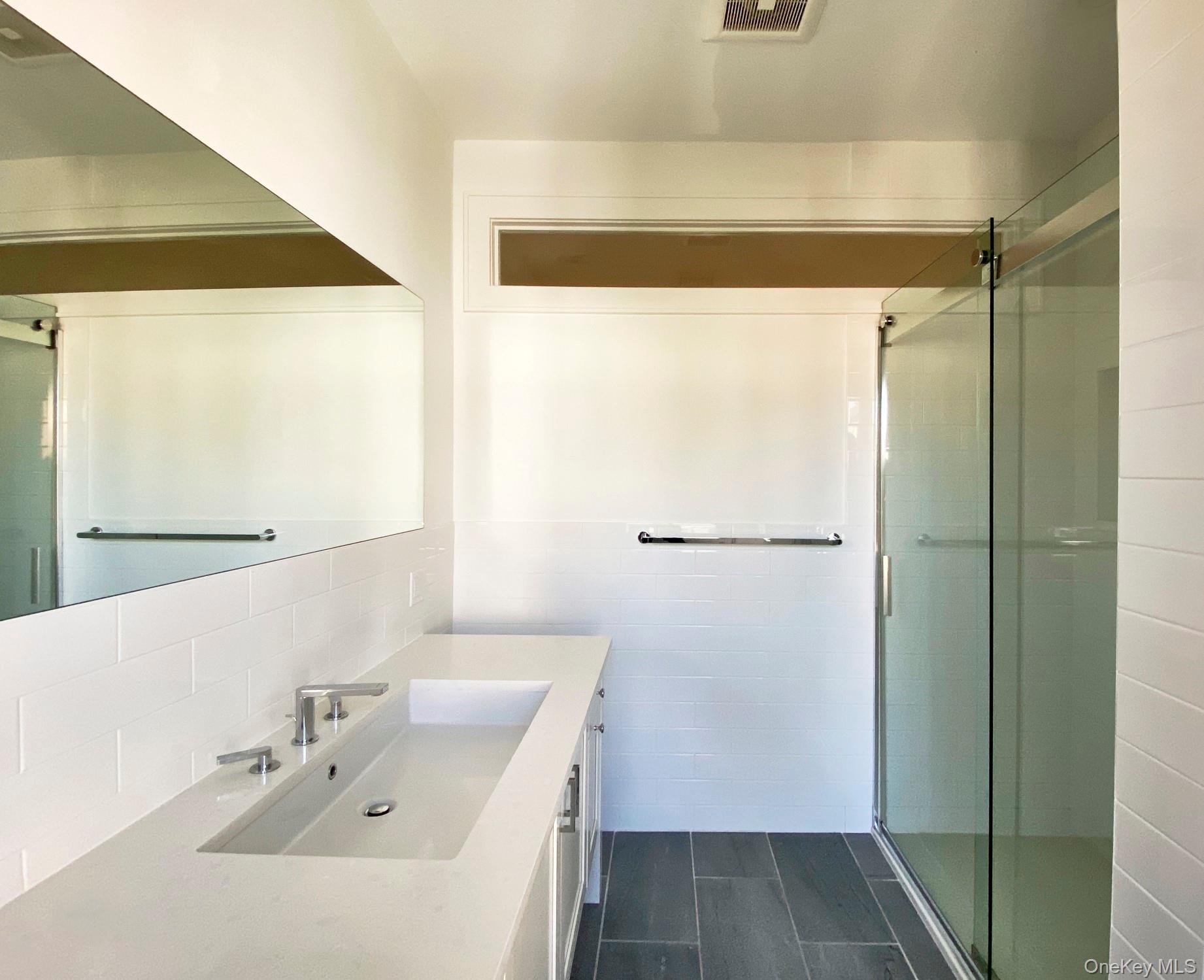 125 Warren Street Hudson, NY 12534 - Photo 19 of 25 a bathroom with a sink and shower