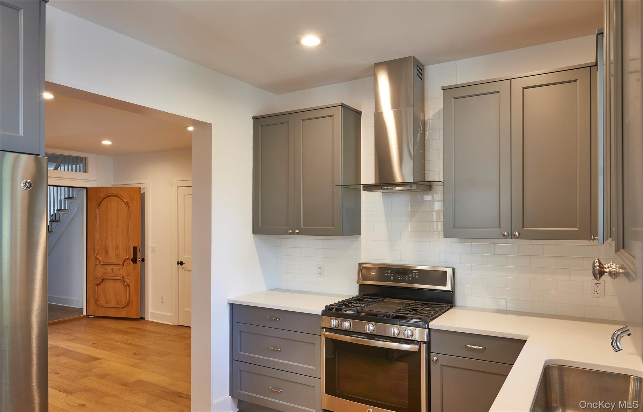 125 Warren Street Hudson, NY 12534 - Photo 7 of 25 a kitchen with stainless steel appliances a refrigerator stove and sink