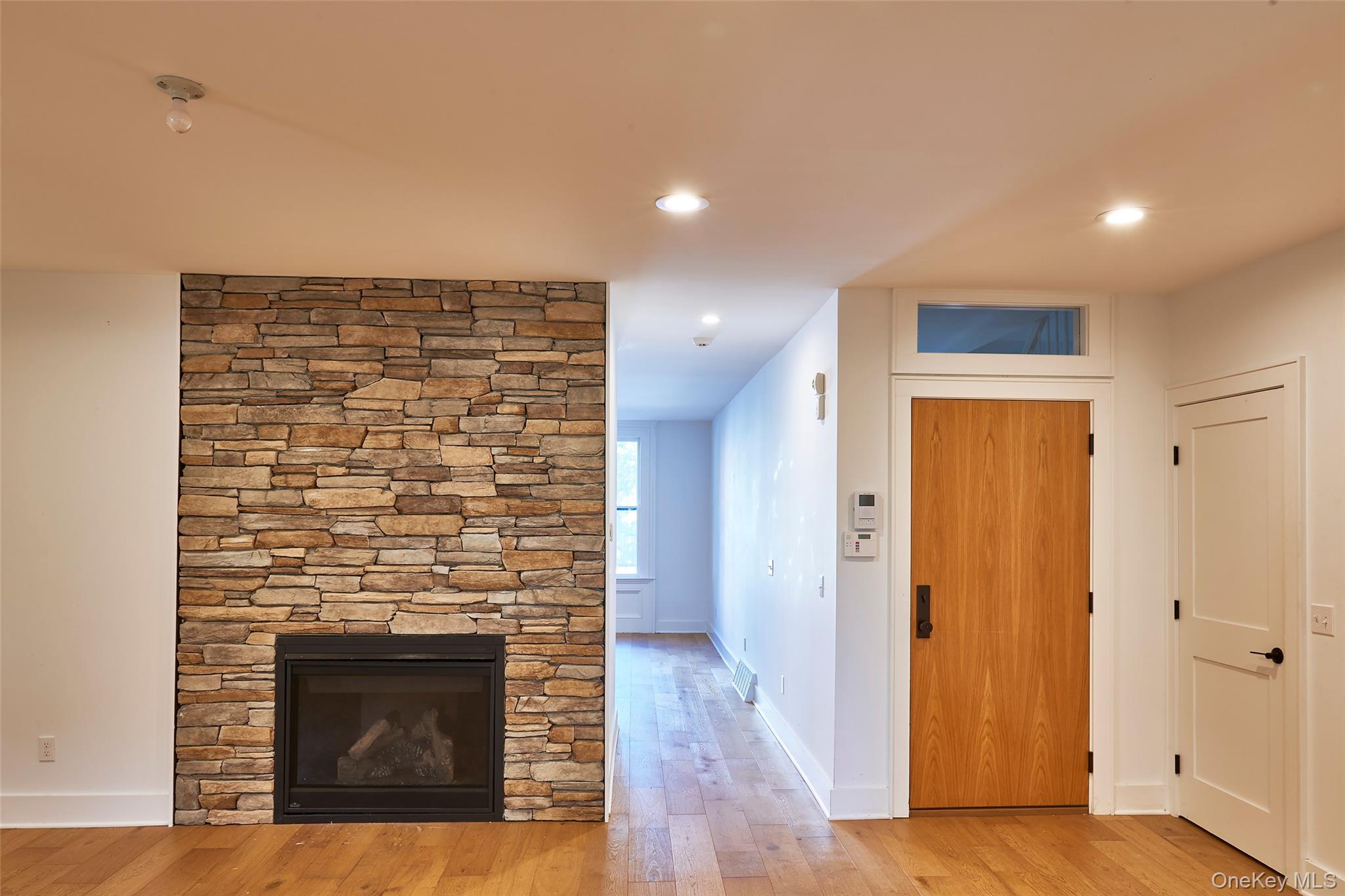 125 Warren Street Hudson, NY 12534 - Photo 10 of 25 a view of an empty room with wooden floor and a fireplace