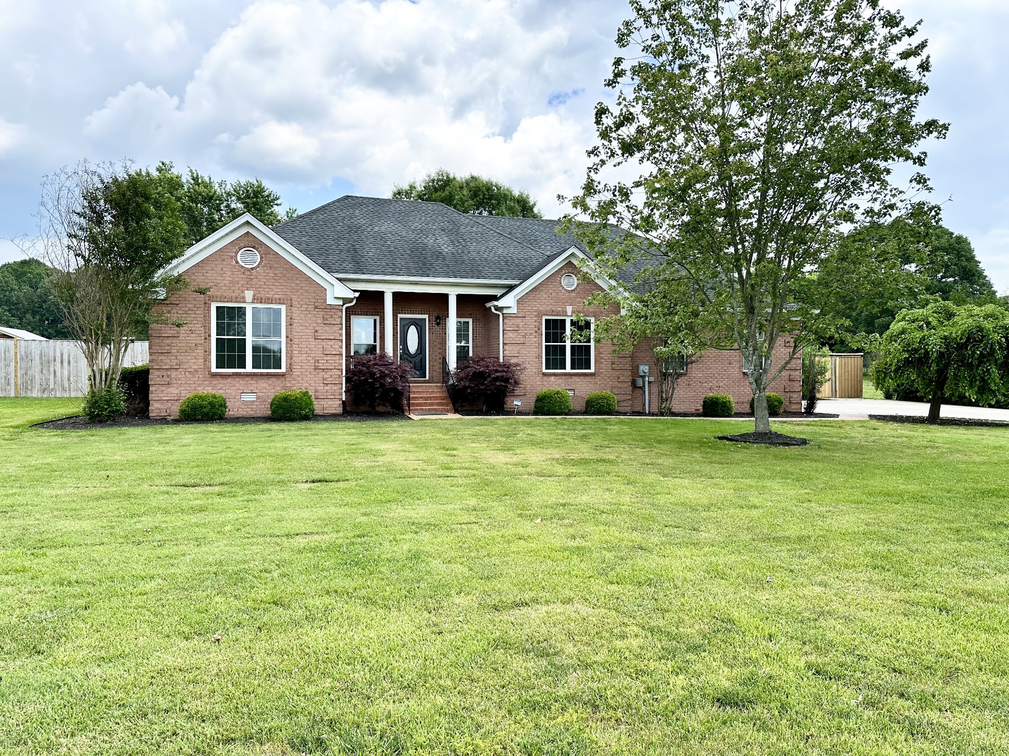 a front view of house with yard and green space