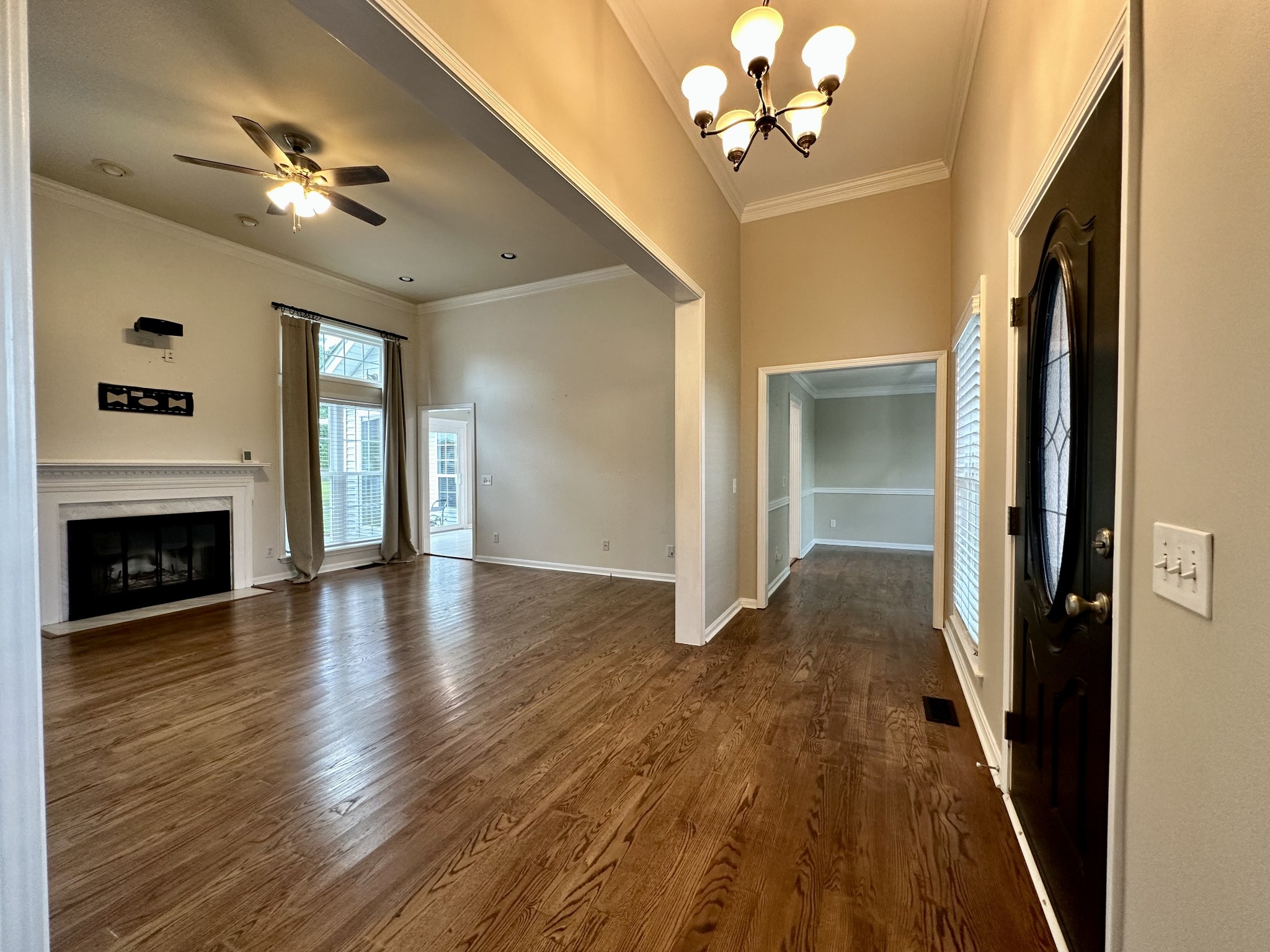 123 Biggs Road Cottontown, TN 37048 - Photo 16 of 39 a view of a livingroom with a fireplace wooden floor and a ceiling fan