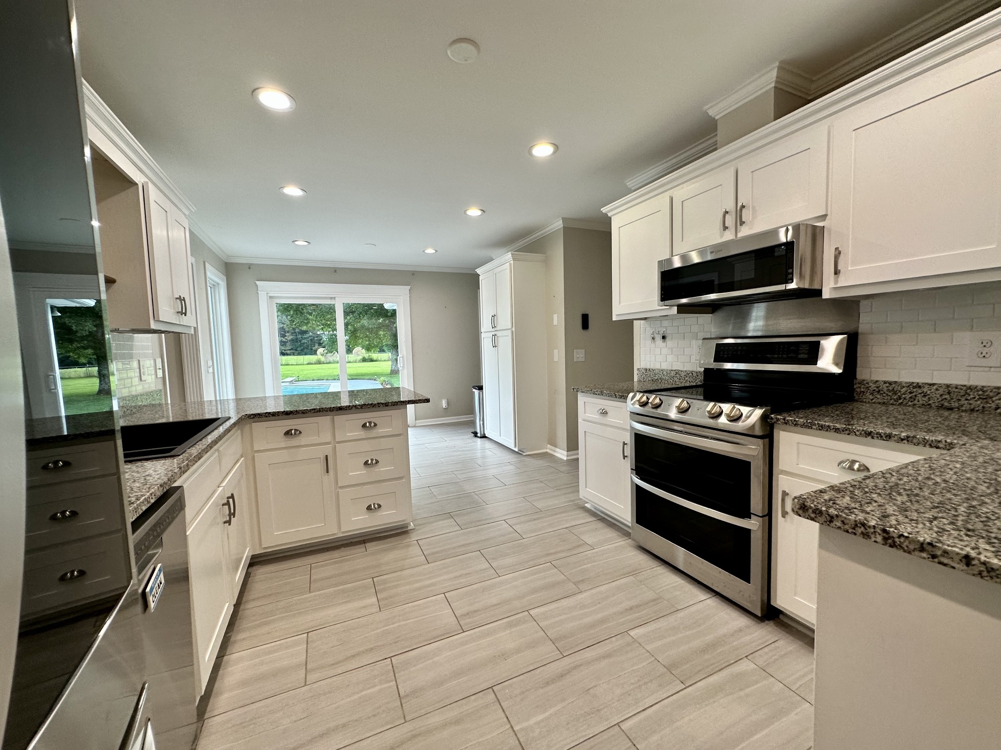 123 Biggs Road Cottontown, TN 37048 - Photo 19 of 39 a large kitchen with stainless steel appliances granite countertop a stove and a sink