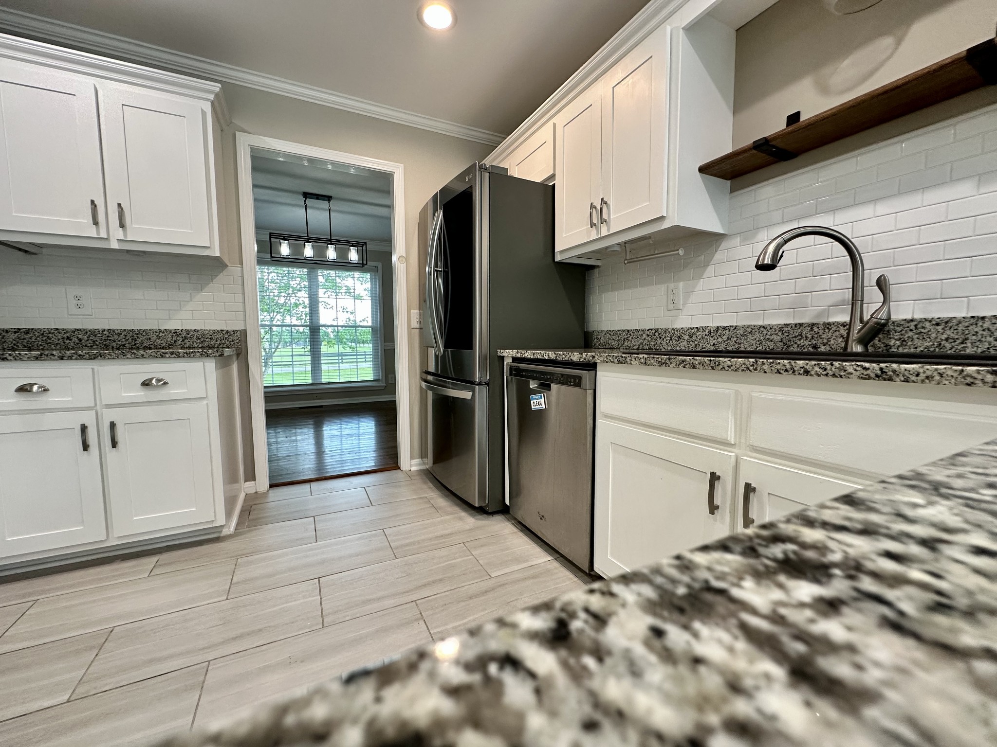 123 Biggs Road Cottontown, TN 37048 - Photo 21 of 39 a kitchen with granite countertop a stove a sink and a refrigerator