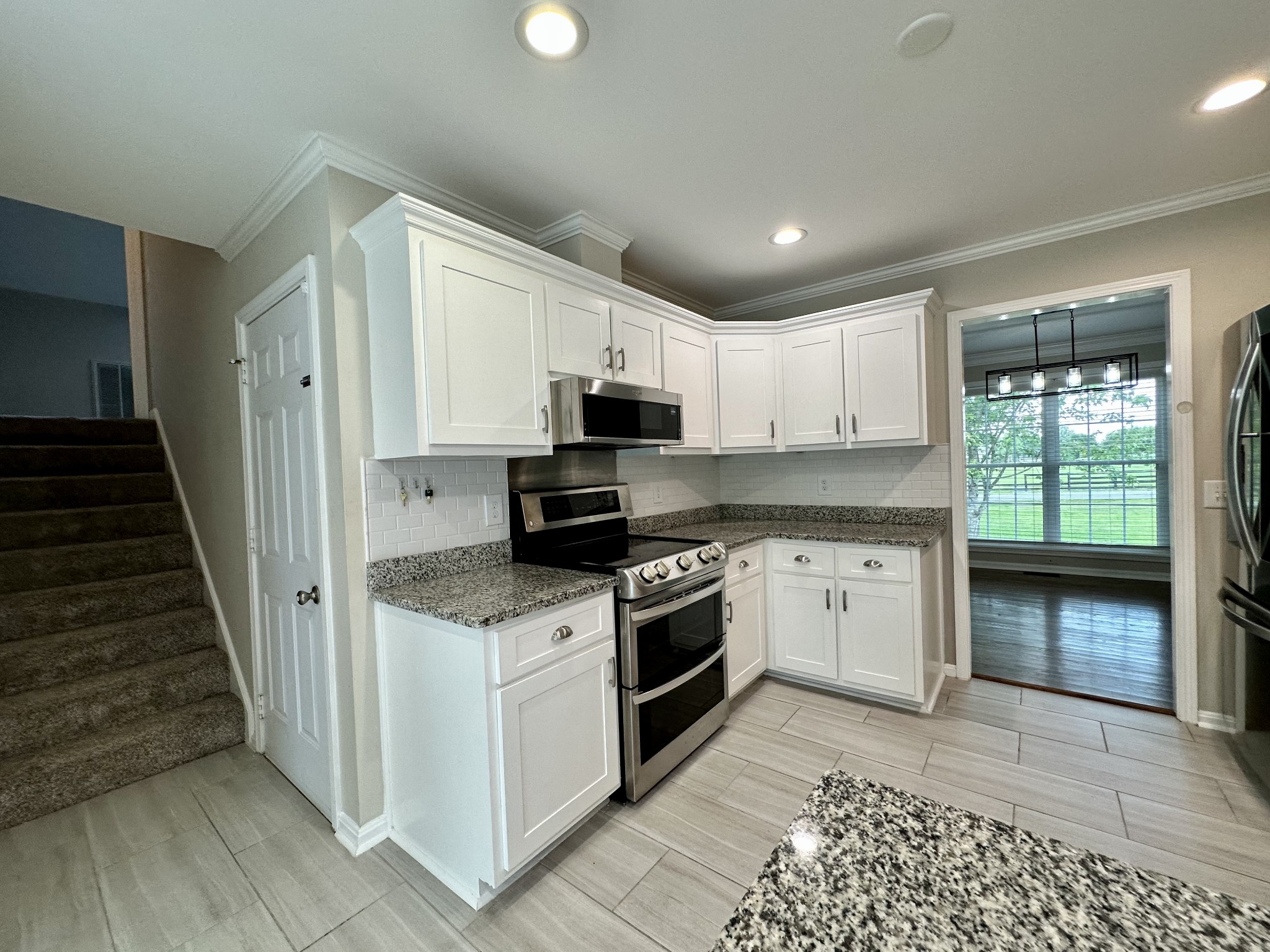 123 Biggs Road Cottontown, TN 37048 - Photo 22 of 39 a kitchen with granite countertop a stove top oven and cabinets