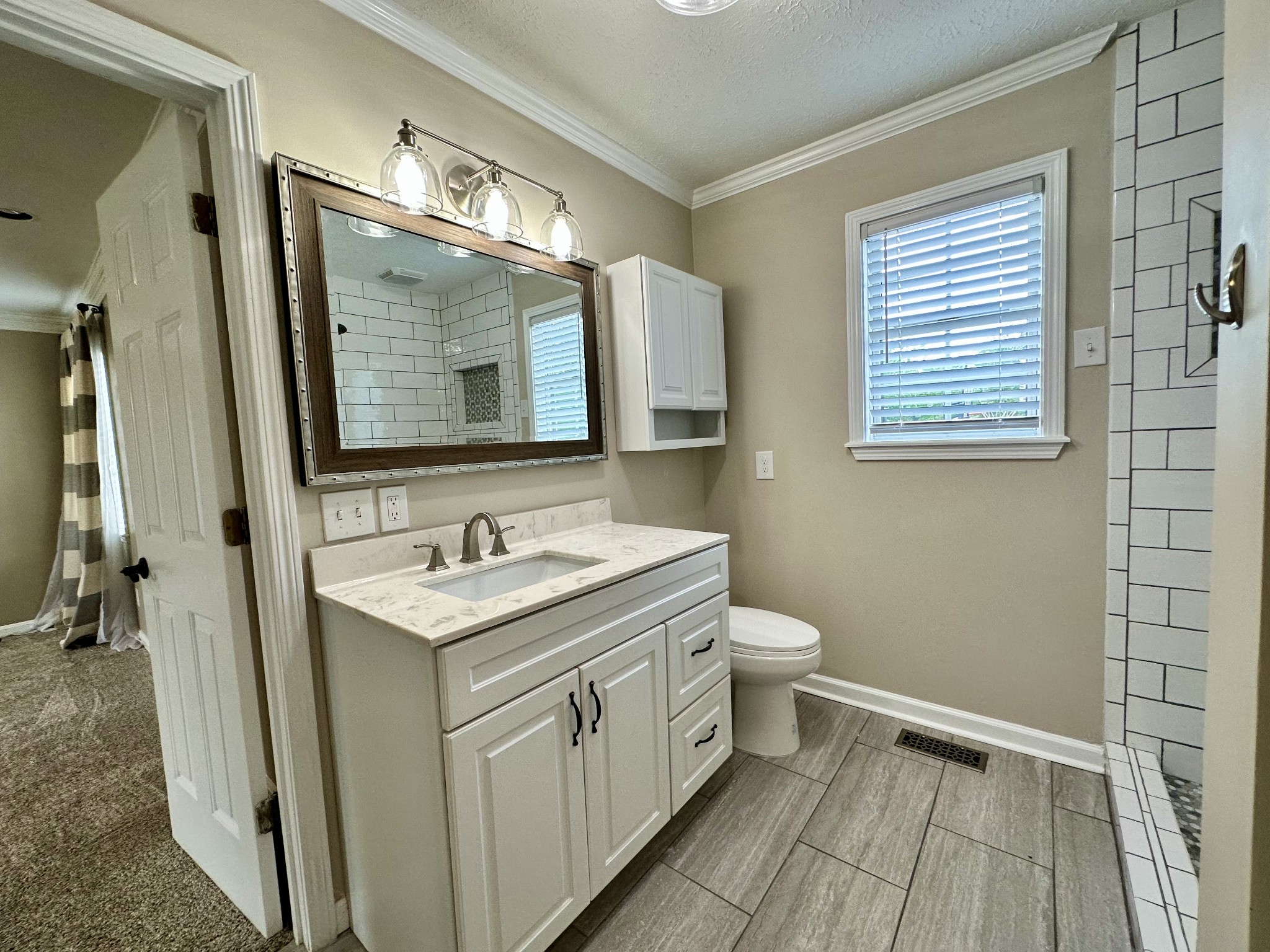 123 Biggs Road Cottontown, TN 37048 - Photo 28 of 39 a bathroom with a toilet sink and mirror