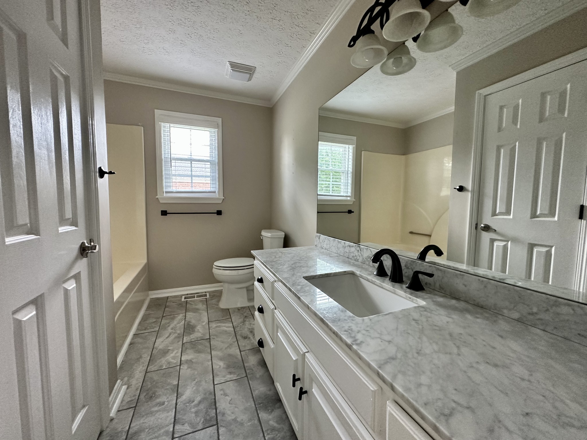 123 Biggs Road Cottontown, TN 37048 - Photo 31 of 39 a bathroom with a sink a toilet a mirror and shower