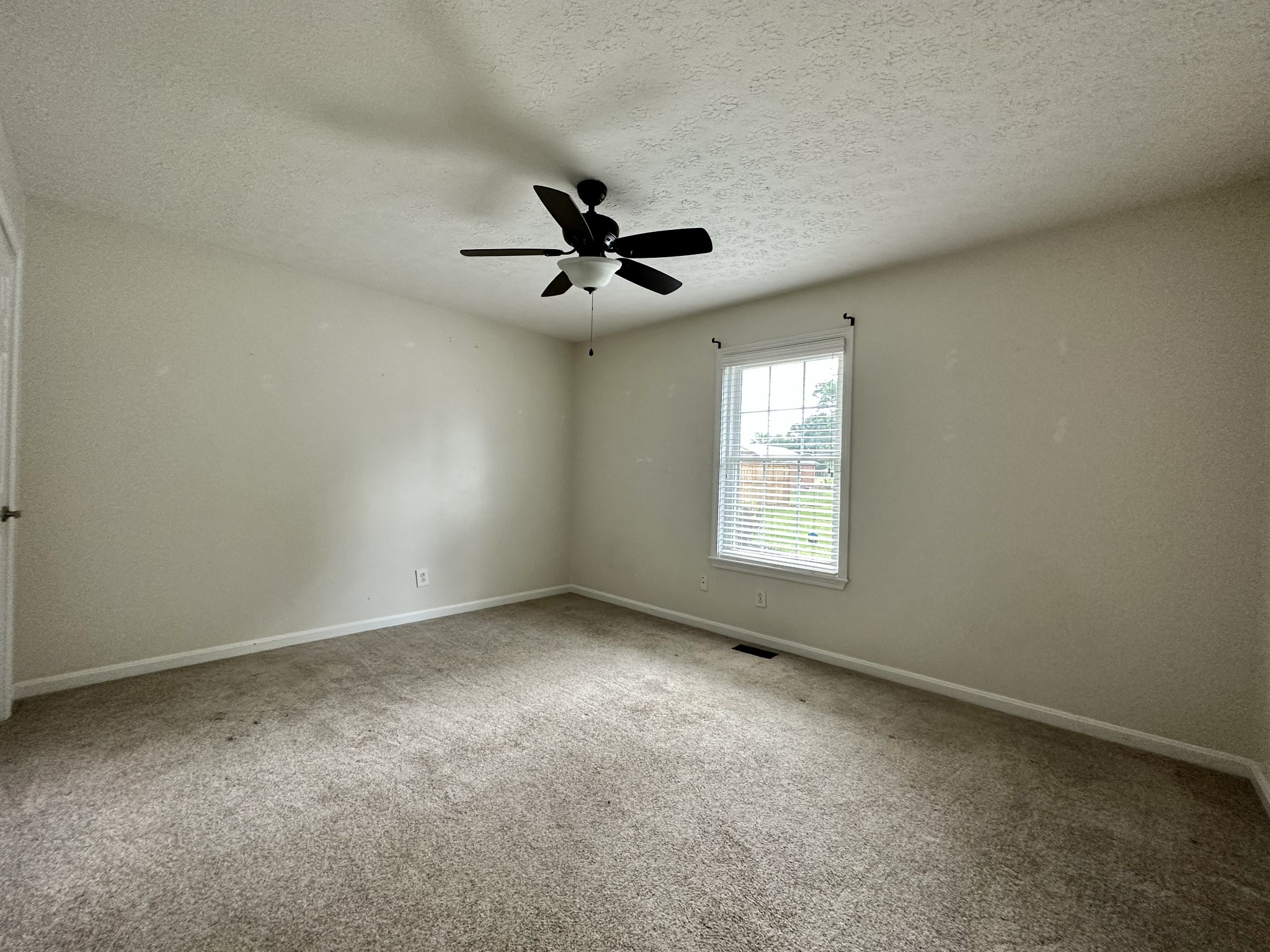 123 Biggs Road Cottontown, TN 37048 - Photo 32 of 39 an empty room with ceiling fan and windows