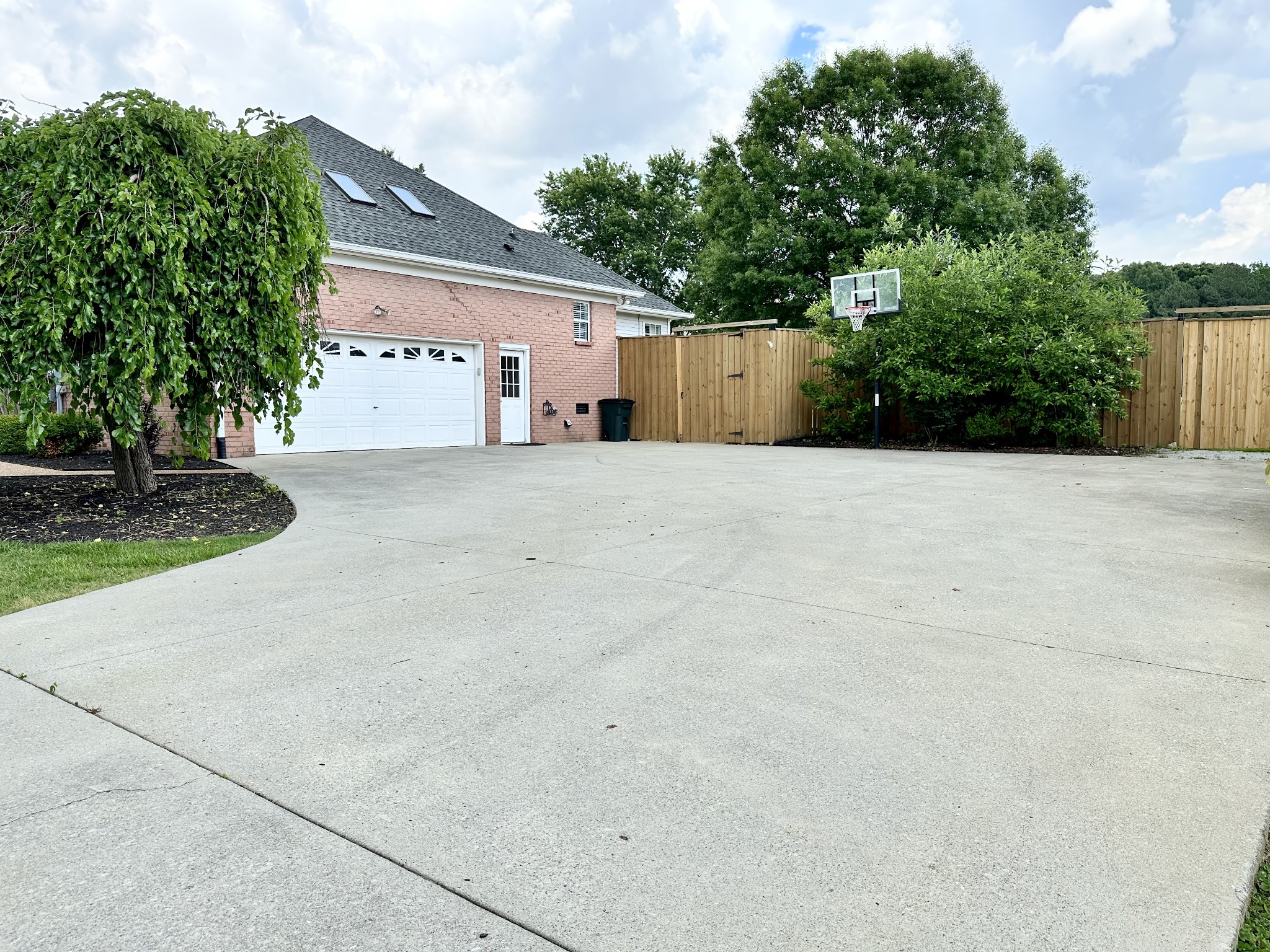 123 Biggs Road Cottontown, TN 37048 - Photo 5 of 39 a tall house with a yard and garage