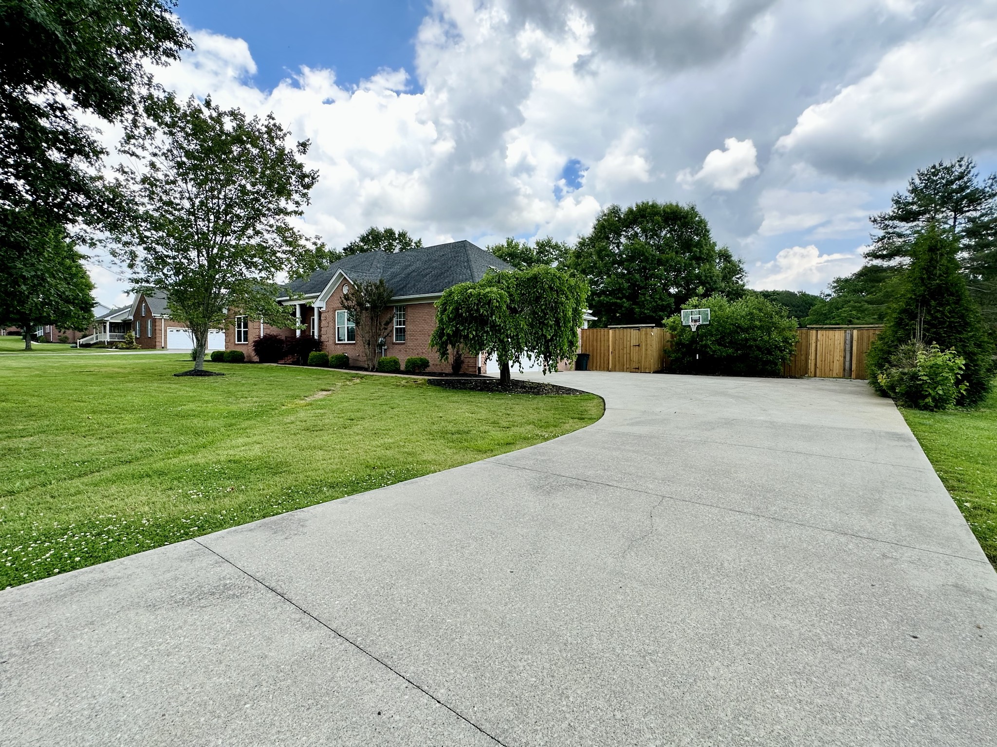 123 Biggs Road Cottontown, TN 37048 - Photo 6 of 39 a view of a white house in a big yard with palm trees