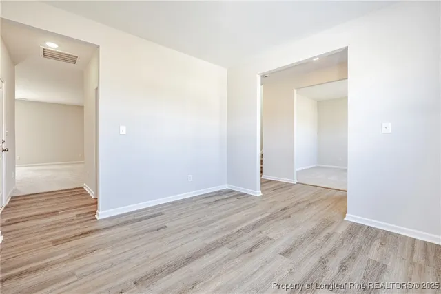 an empty room with wooden floor & closet