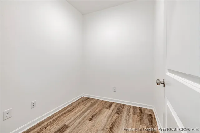 a view of a room with wooden floor