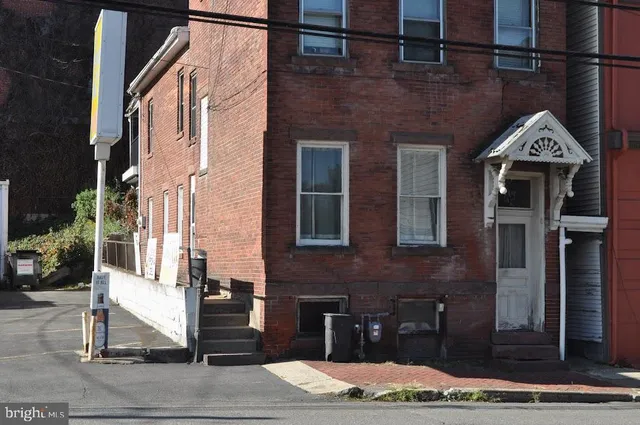 a view of a brick house with many windows