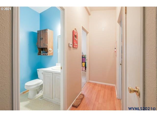 32724 Old Mill Road Lebanon, OR 97355 - Photo 11 of 32 a bathroom with a toilet and a wooden floor