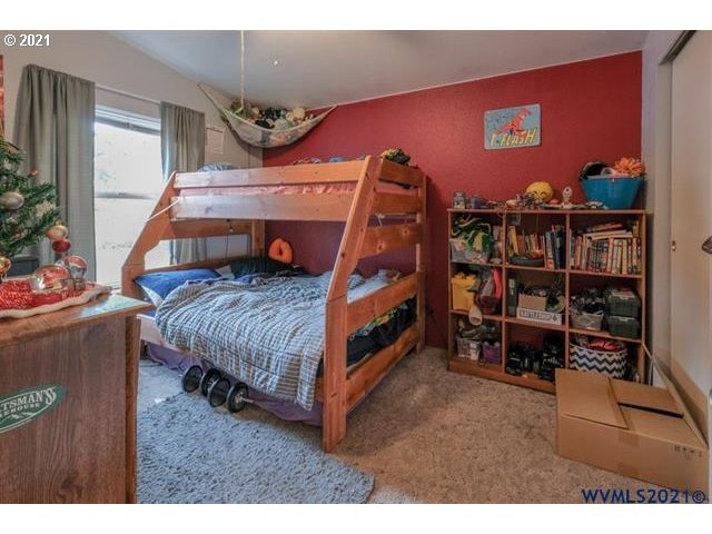 32724 Old Mill Road Lebanon, OR 97355 - Photo 12 of 32 a bedroom with bed and a book shelf