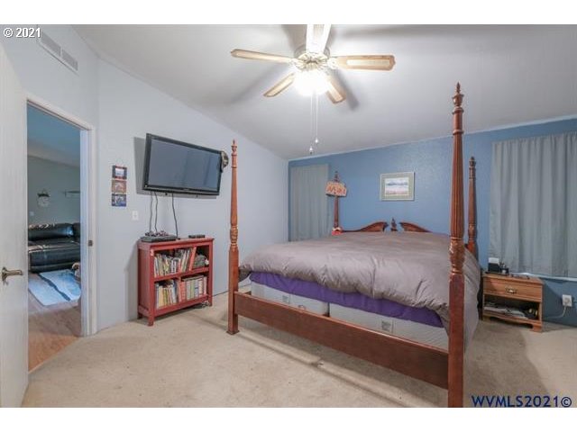 32724 Old Mill Road Lebanon, OR 97355 - Photo 29 of 32 a bedroom with a bed and a flat screen tv