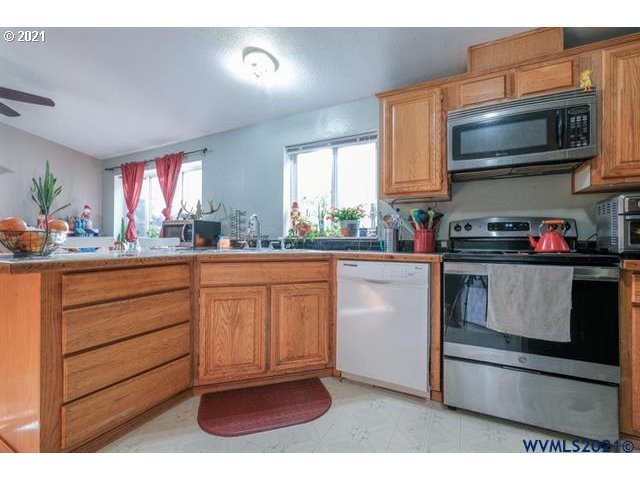 32724 Old Mill Road Lebanon, OR 97355 - Photo 7 of 32 a kitchen with a sink stove and microwave