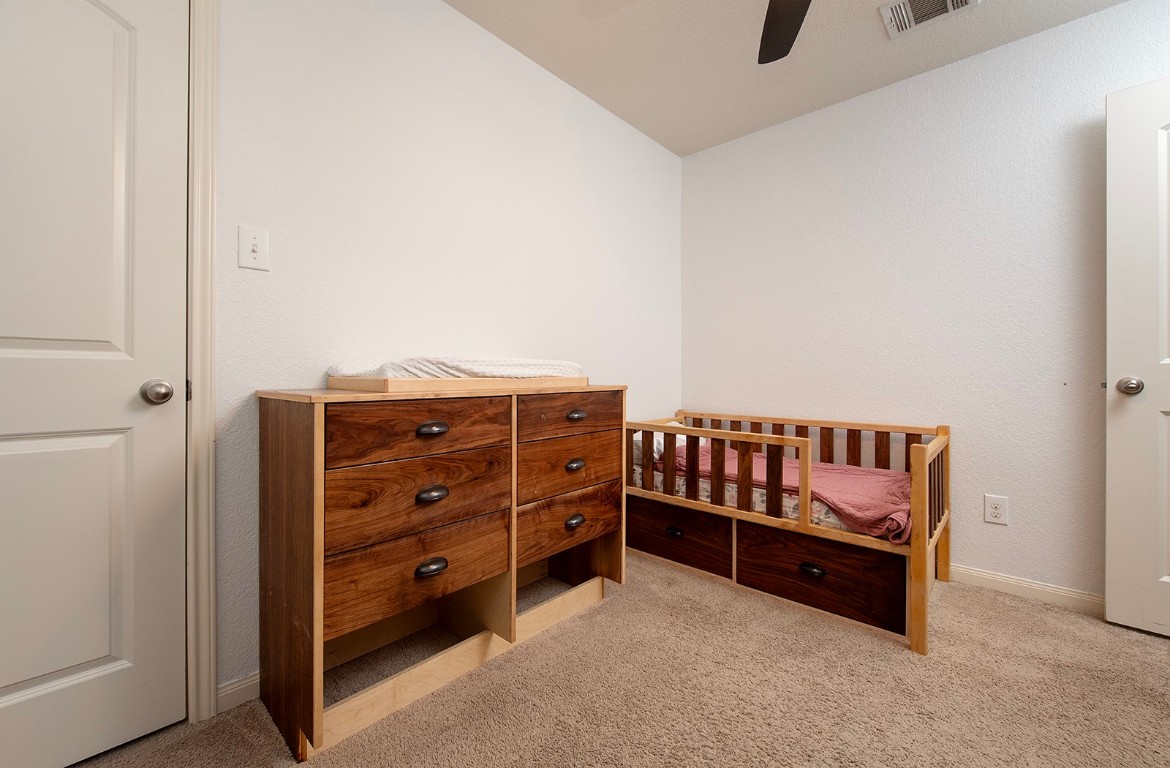 216 Millers Loop Jarrell, TX 76537 - Photo 19 of 31 Bedroom with light colored carpet and a ceiling fan
