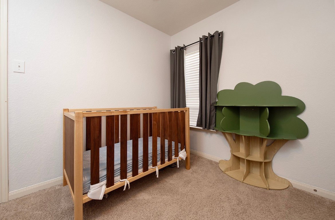 216 Millers Loop Jarrell, TX 76537 - Photo 20 of 31 Carpeted bedroom with a nursery area and ceiling fan