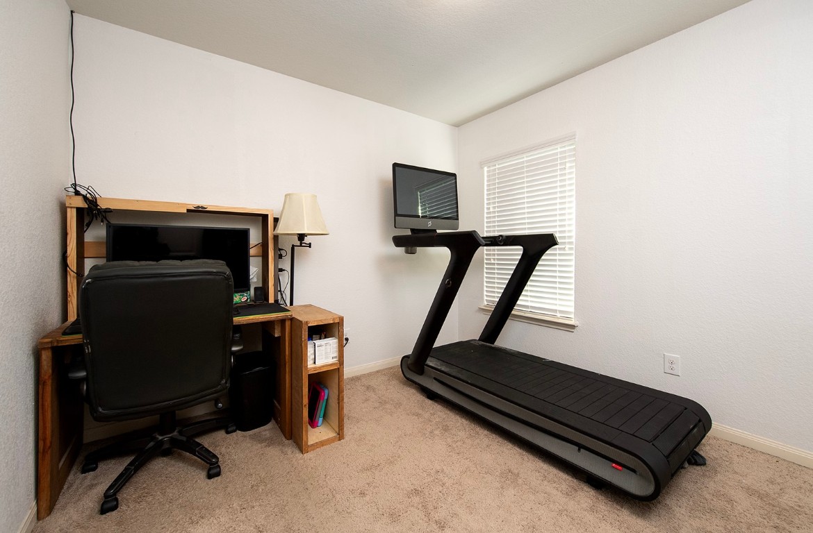 216 Millers Loop Jarrell, TX 76537 - Photo 21 of 31 Home office with baseboards and light colored carpet