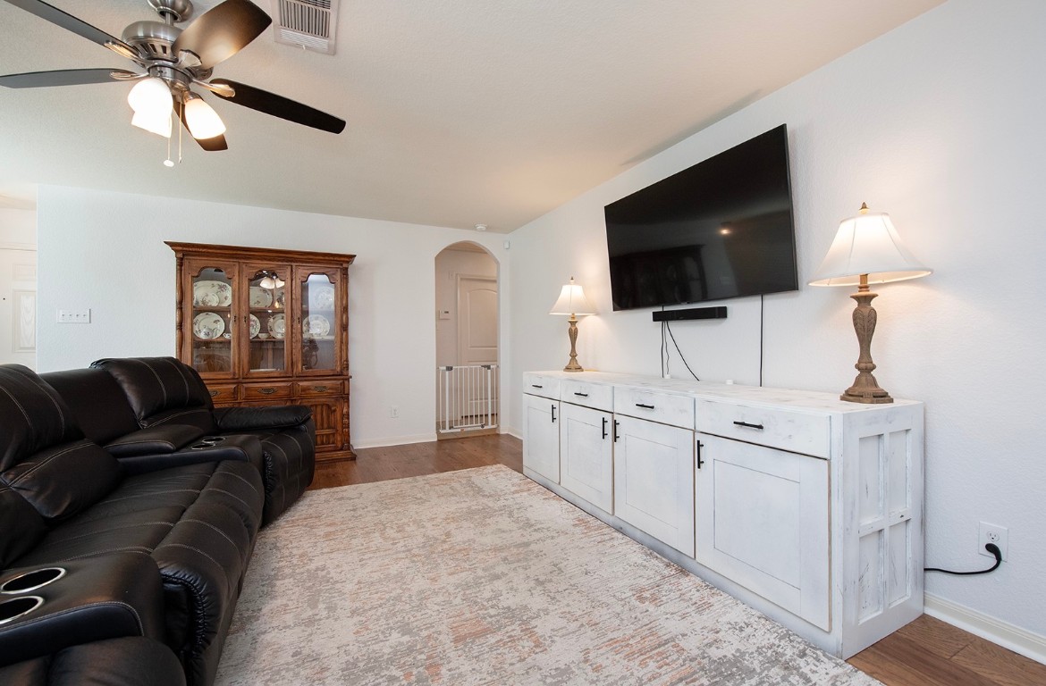 216 Millers Loop Jarrell, TX 76537 - Photo 4 of 31 Living area featuring arched walkways, dark hard wood flooring, and ceiling fan