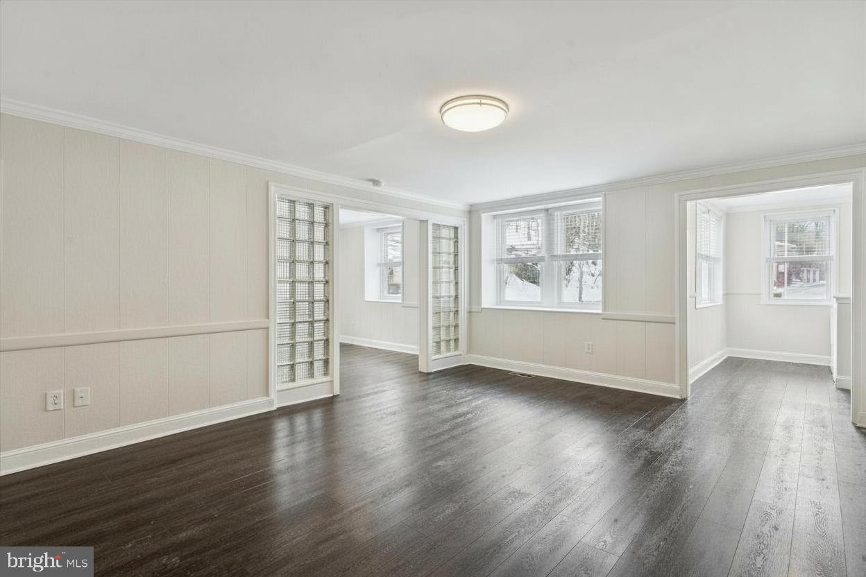 3 South Brandywine Avenue, Unit 1 Modena, PA 19320 - Photo 5 of 27 an empty room with wooden floor and windows
