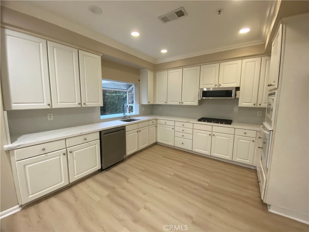 721 South 3rd Avenue, Unit A Arcadia, CA 91006 - Photo 5 of 16 a kitchen with white cabinets stainless steel appliances and sink