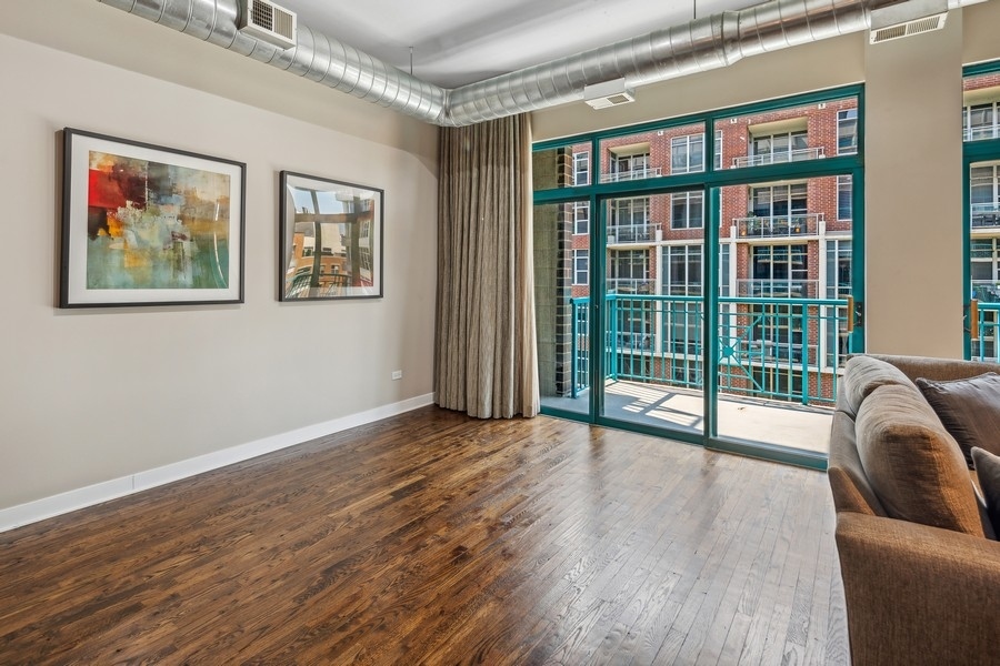 910 West Madison Street, Unit 602 Chicago, IL 60607 - Photo 9 of 15 a view of livingroom with furniture and floor to ceiling window