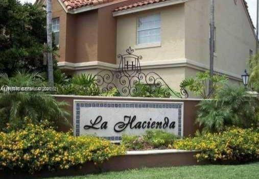 18308 Northwest 68th Avenue, Unit B Hialeah, FL 33015 - Photo 1 of 10 a sign on the side of a building