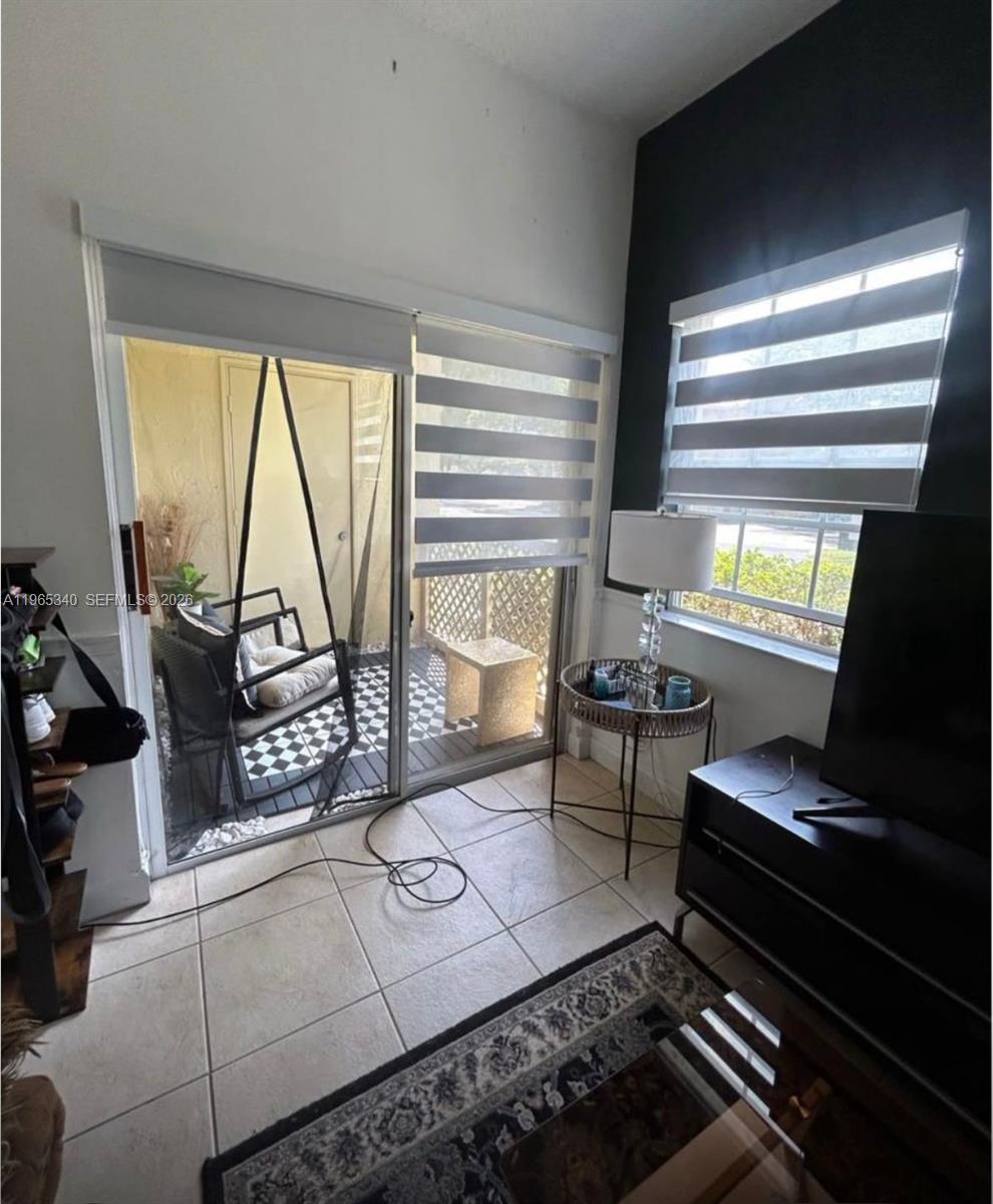 18308 Northwest 68th Avenue, Unit B Hialeah, FL 33015 - Photo 4 of 10 a living room with furniture