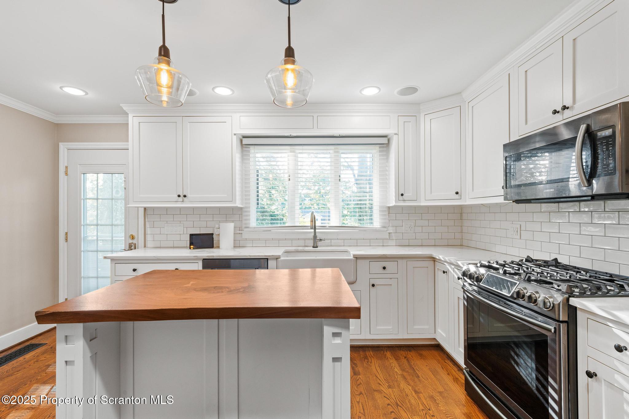 111 Upper Knapp Road Clarks Summit, PA 18411 - Photo 11 of 52 a kitchen with granite countertop a sink stainless steel appliances and cabinets