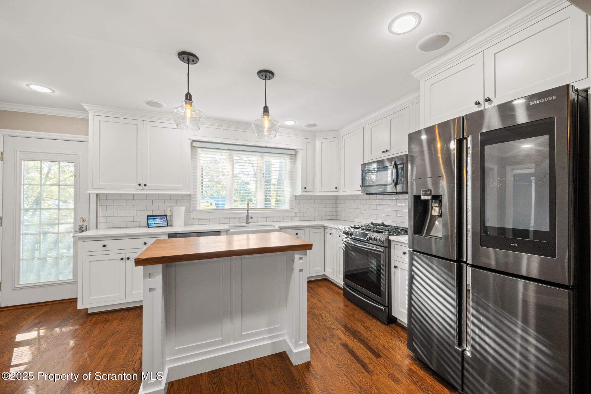 111 Upper Knapp Road Clarks Summit, PA 18411 - Photo 13 of 52 a kitchen with stainless steel appliances granite countertop a refrigerator a sink dishwasher a stove and white cabinets with wooden floor