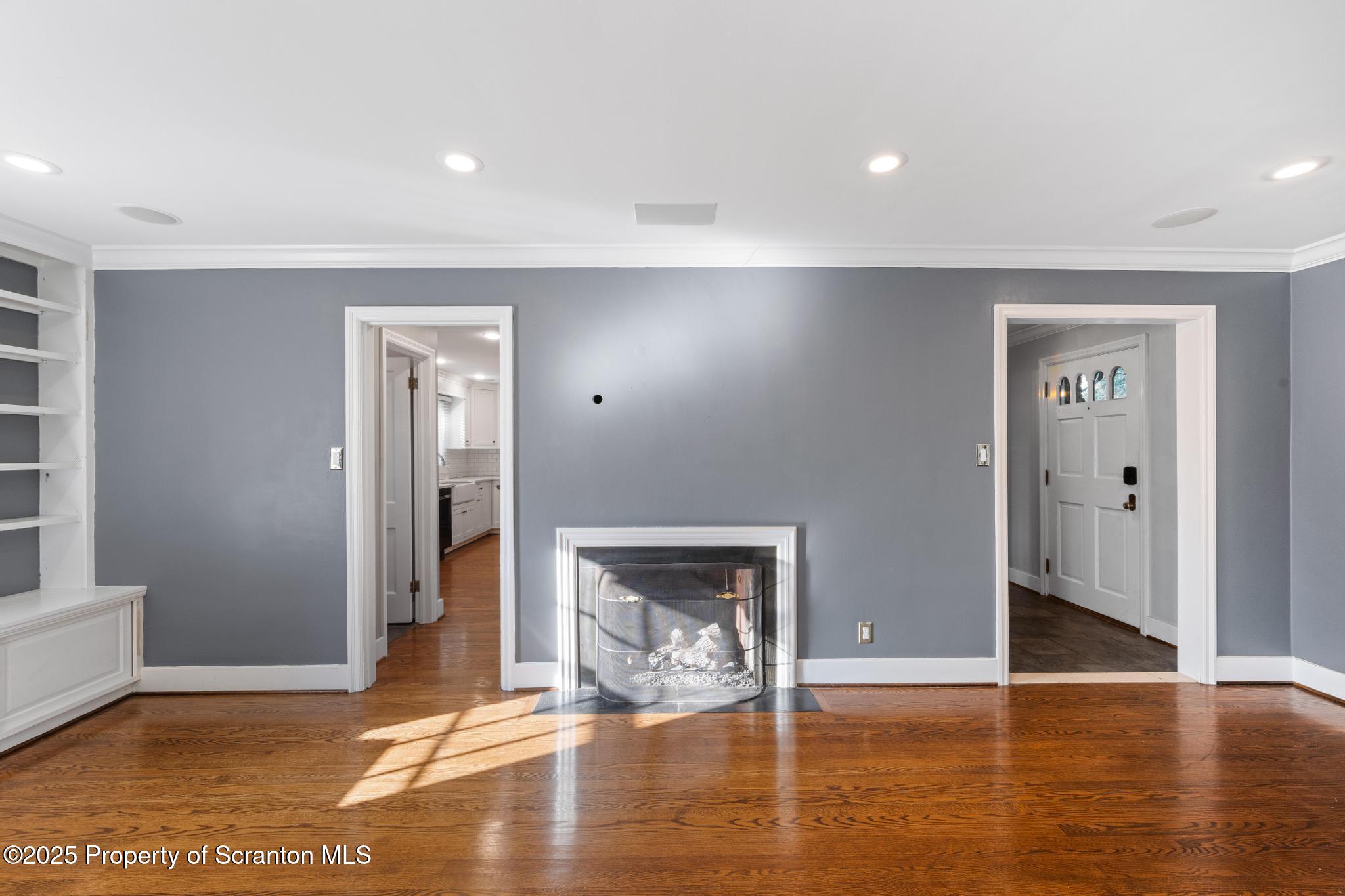 111 Upper Knapp Road Clarks Summit, PA 18411 - Photo 14 of 52 a view of an empty room with wooden floor and a fireplace