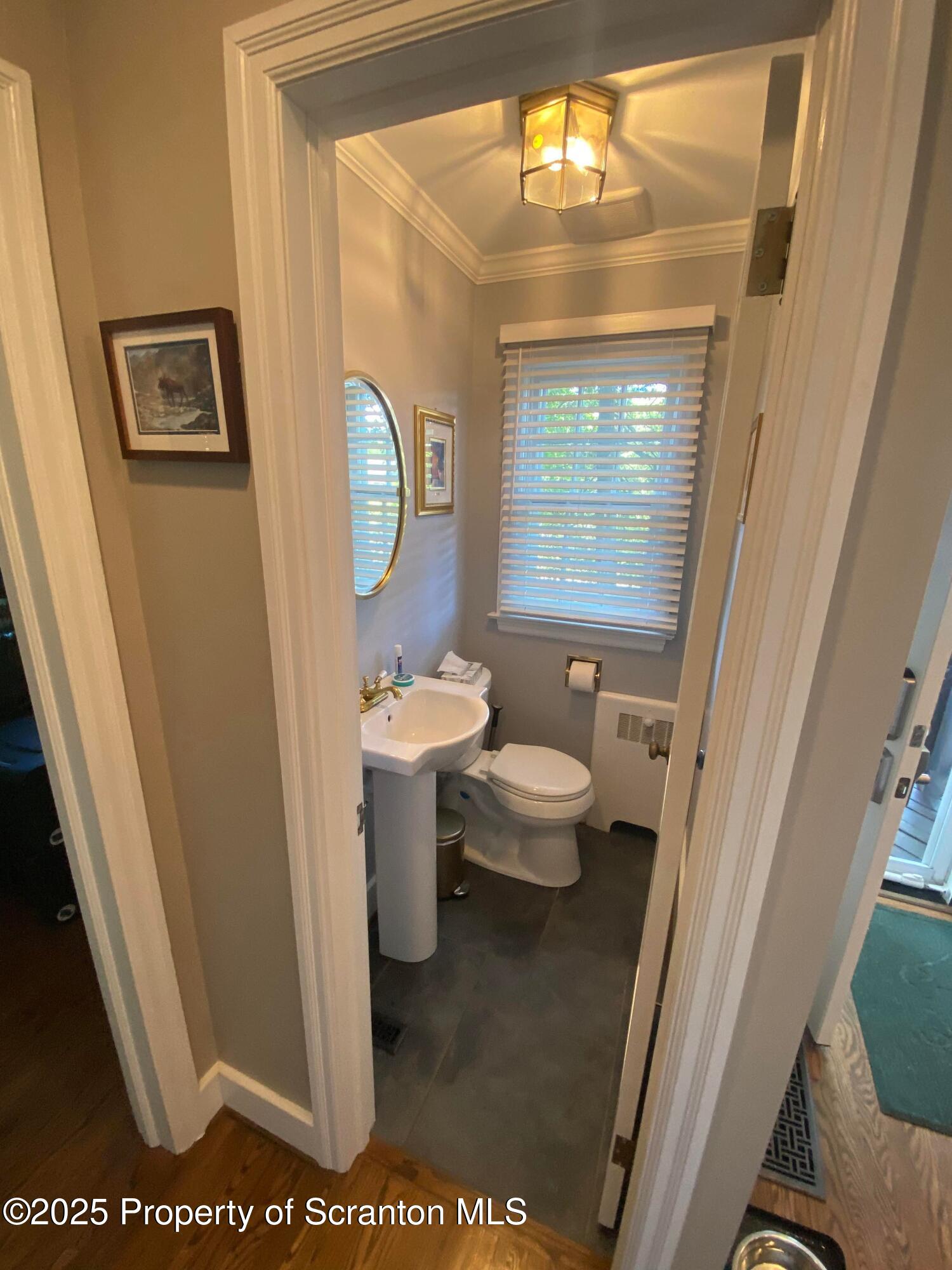 111 Upper Knapp Road Clarks Summit, PA 18411 - Photo 21 of 52 a bathroom with a toilet a sink and a large mirror