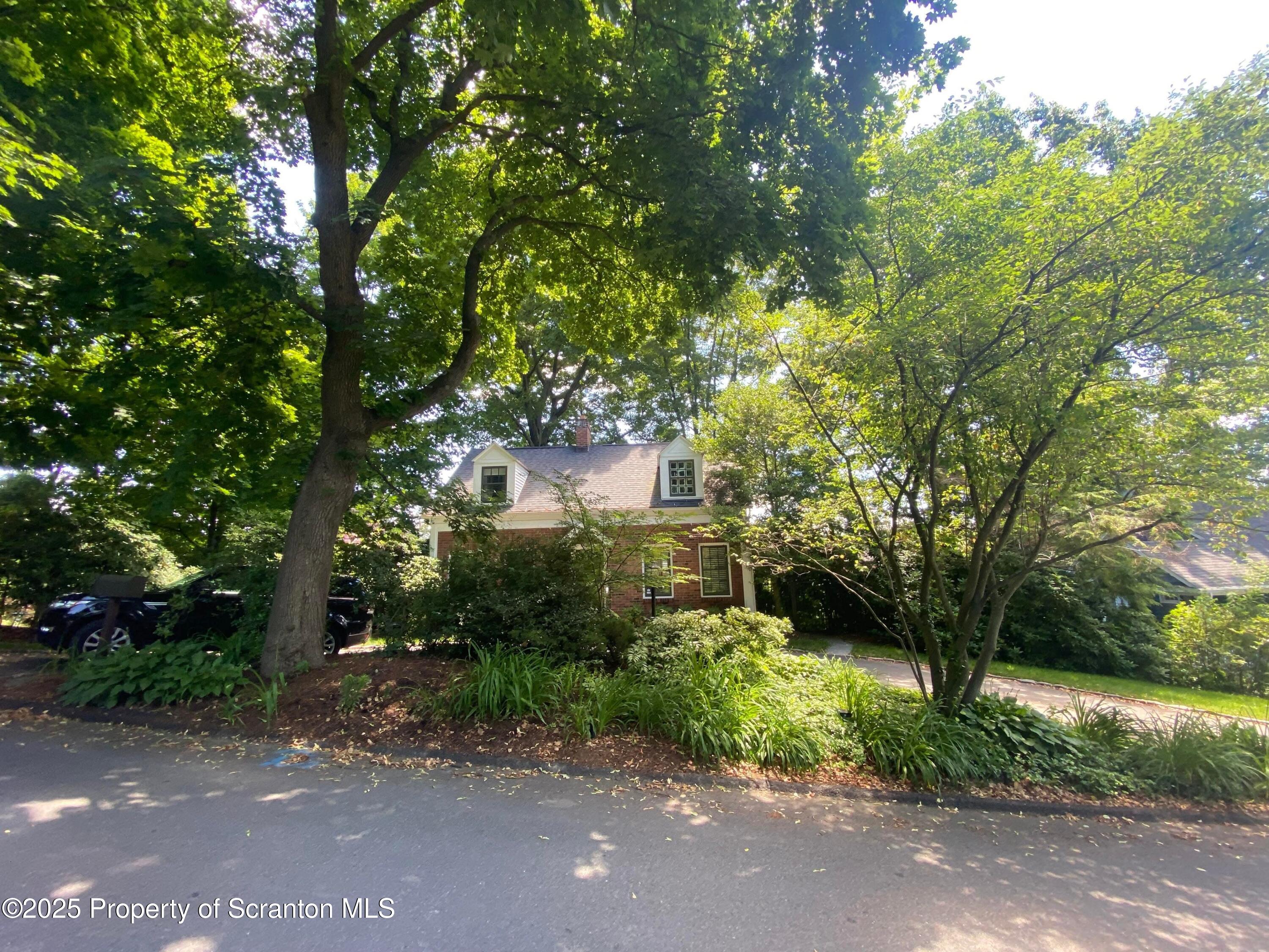 111 Upper Knapp Road Clarks Summit, PA 18411 - Photo 52 of 52 a view of a street with flower plants and large trees