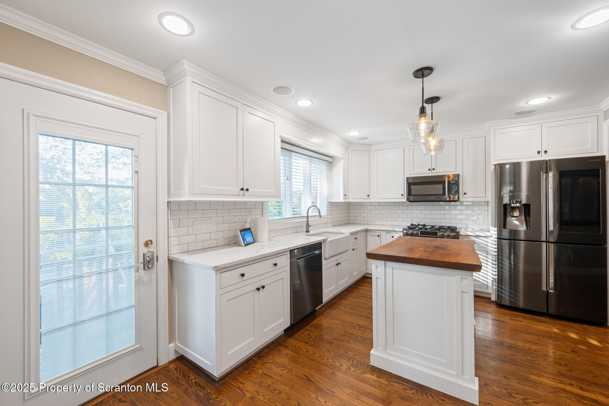 111 Upper Knapp Road Clarks Summit, PA 18411 - Photo 10 of 52 a kitchen with stainless steel appliances granite countertop a refrigerator a sink dishwasher a stove and white countertops with wooden floor