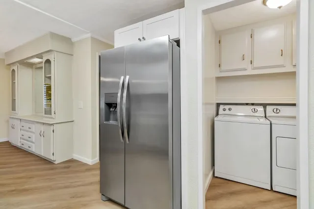 a kitchen with cabinets and stainless steel appliances