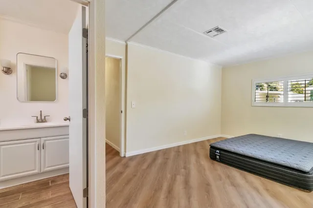 a view of a room with a sink and a mirror