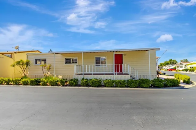 a front view of a house with a garden