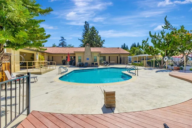 swimming pool with outdoor seating and yard