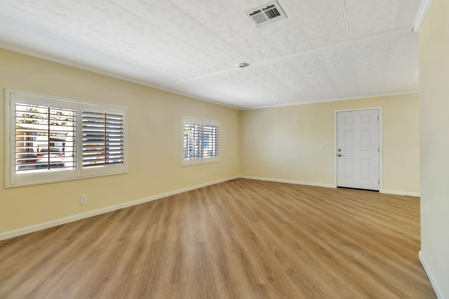 3263 Vineyard, Unit 132 Pleasanton, CA 94566 - Photo 7 of 34 a view of an empty room with wooden floor and a window
