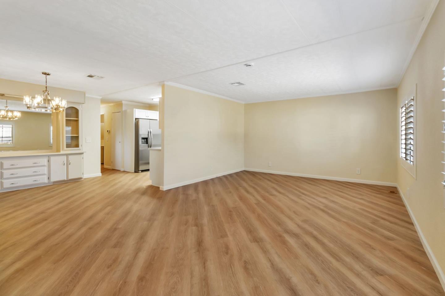 3263 Vineyard, Unit 132 Pleasanton, CA 94566 - Photo 9 of 34 an empty room with wooden floor and a bathroom