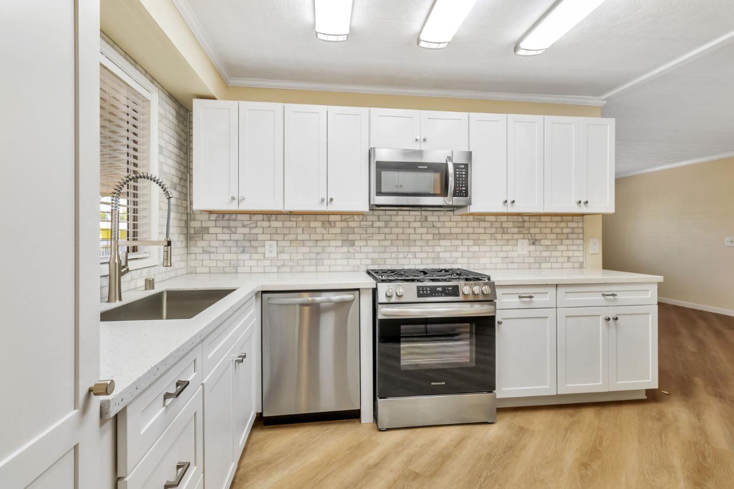 3263 Vineyard, Unit 132 Pleasanton, CA 94566 - Photo 10 of 34 a kitchen with white cabinets and stainless steel appliances