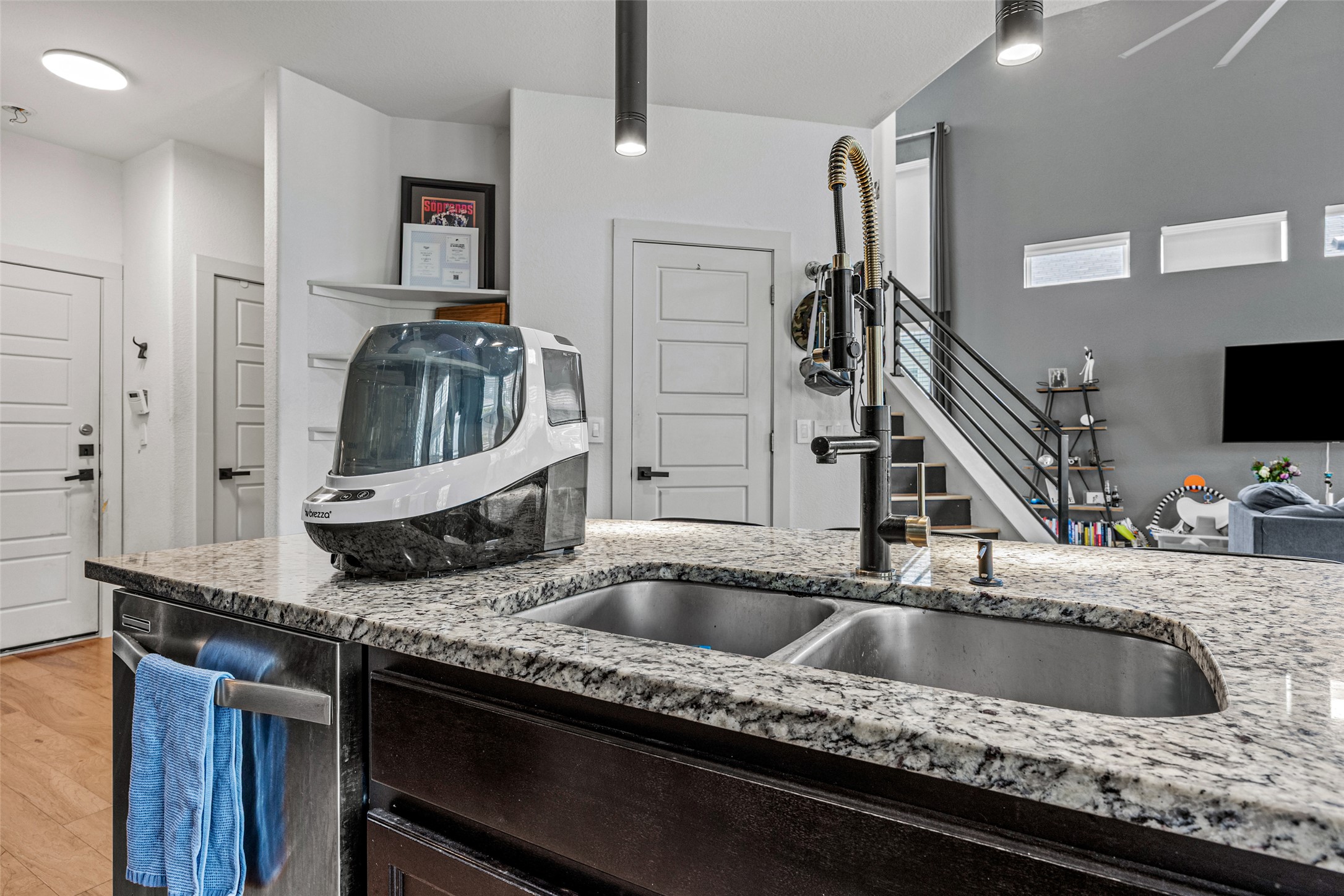 1408 Homespun Road Austin, TX 78745 - Photo 9 of 20 A well-appointed kitchen island with gleaming countertops serves as the heart of this contemporary living space.