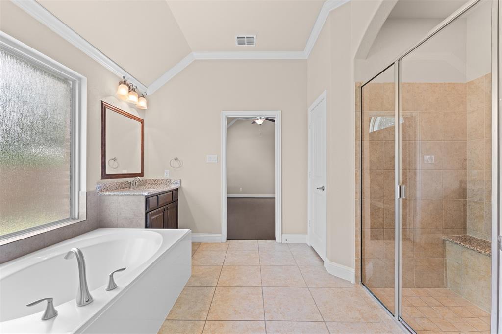 600 Fishback Circle Plano, TX 75074 - Photo 14 of 38 a bathroom with a tub shower and sink