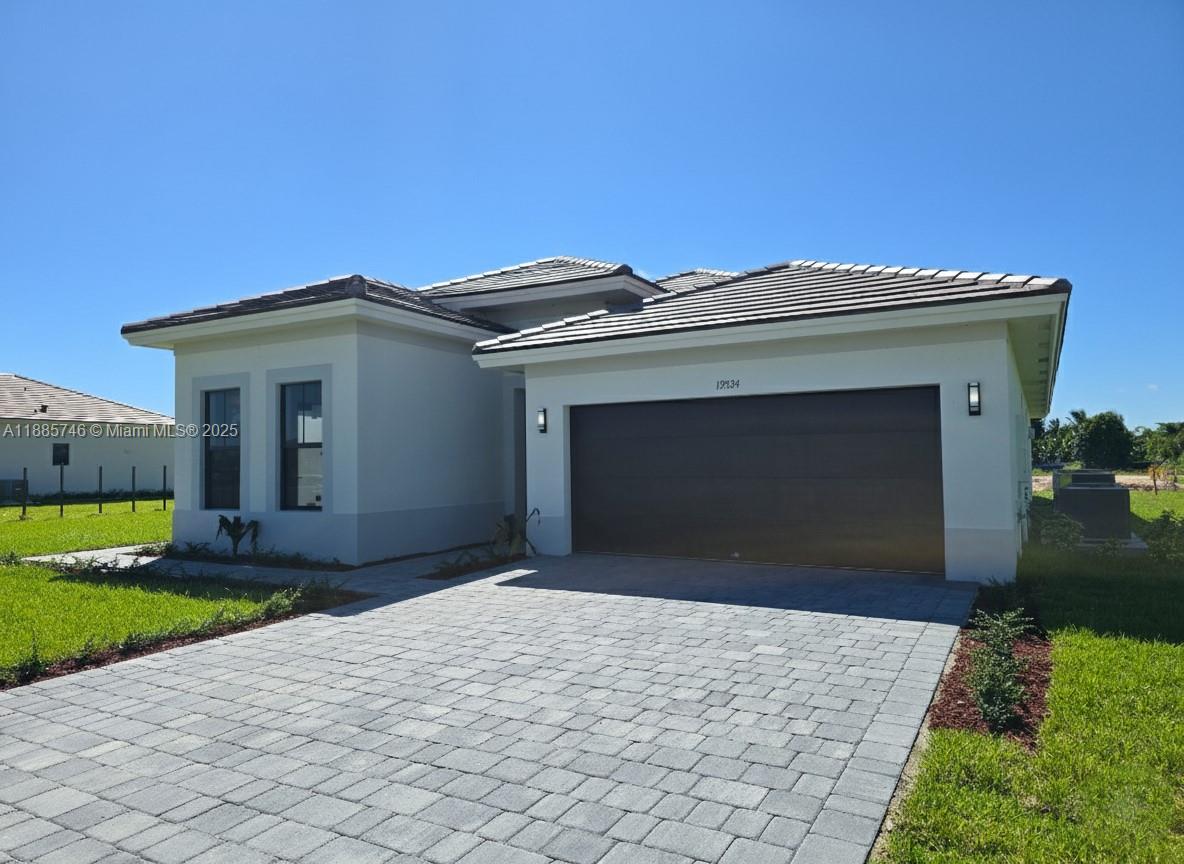 a front view of a house with a yard